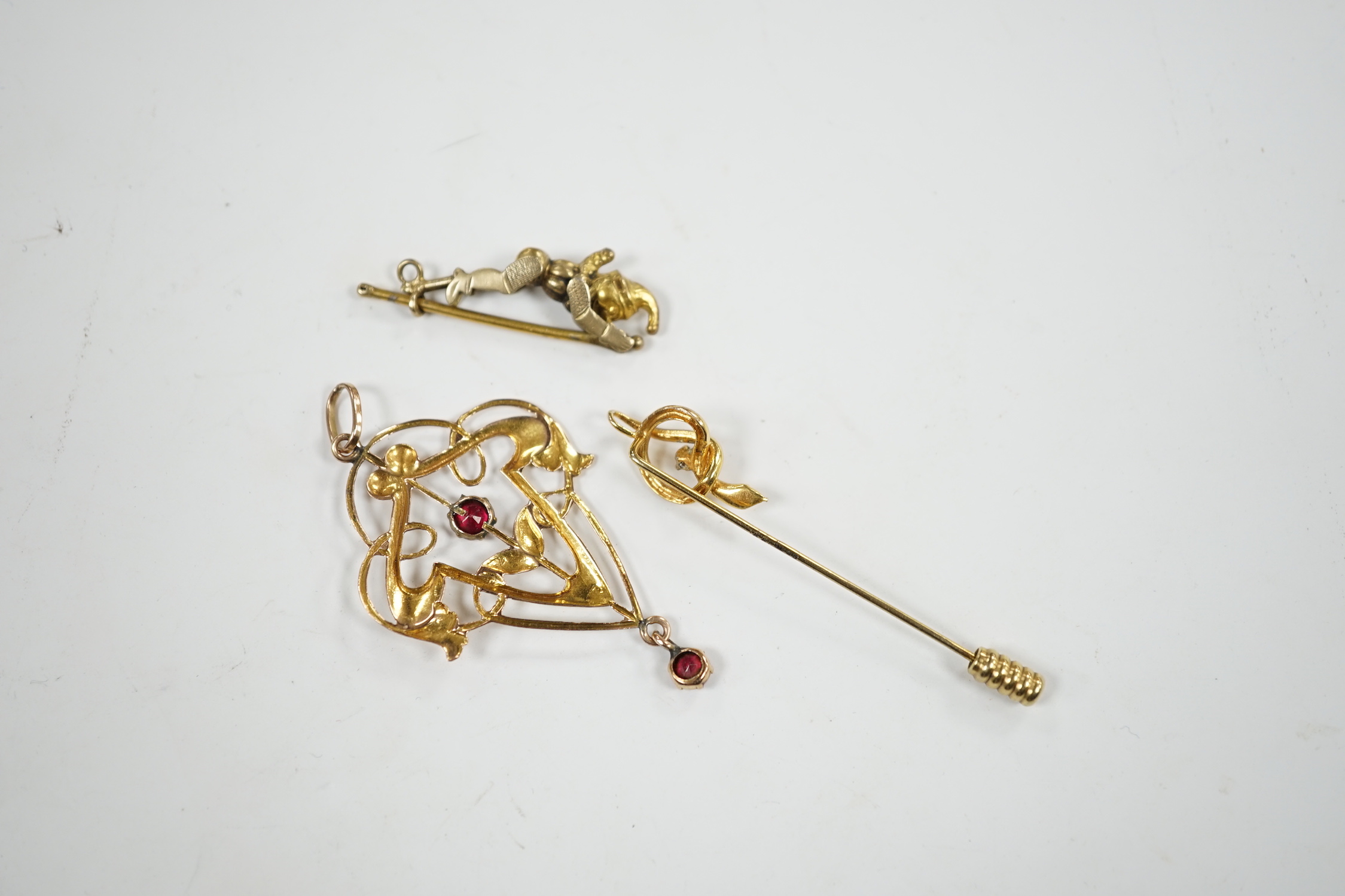 An Art Nouveau yellow metal and two stone gem set drop pendant, 53mm, an articulated Mr Punch charm and a modern 9ct gold and diamond chip set serpent stick pin.